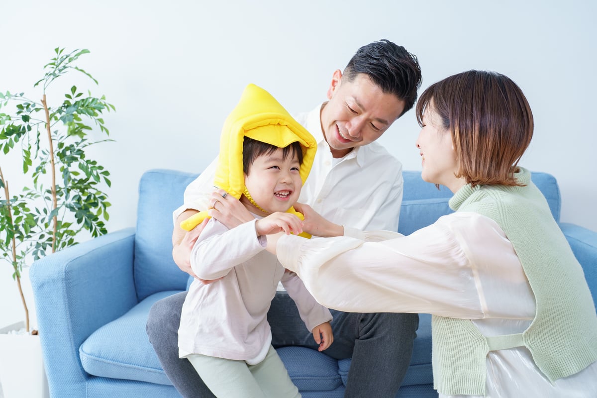 A child wearing a disaster prevention hood